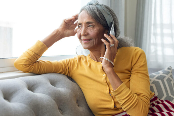 Older woman on the phone and looking out the window