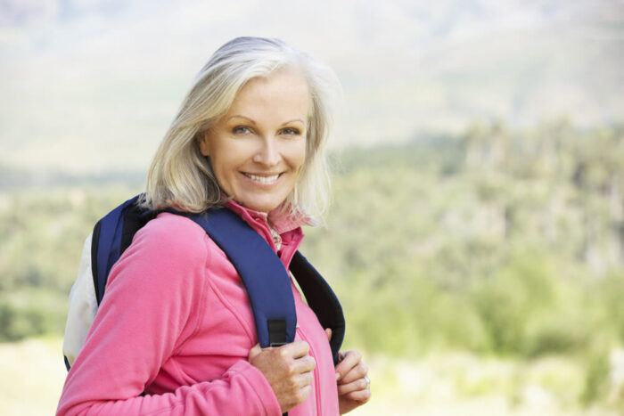 Mature woman hiking with backpack