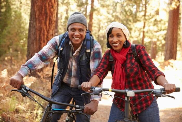 Mature couple riding their bikes in the woods